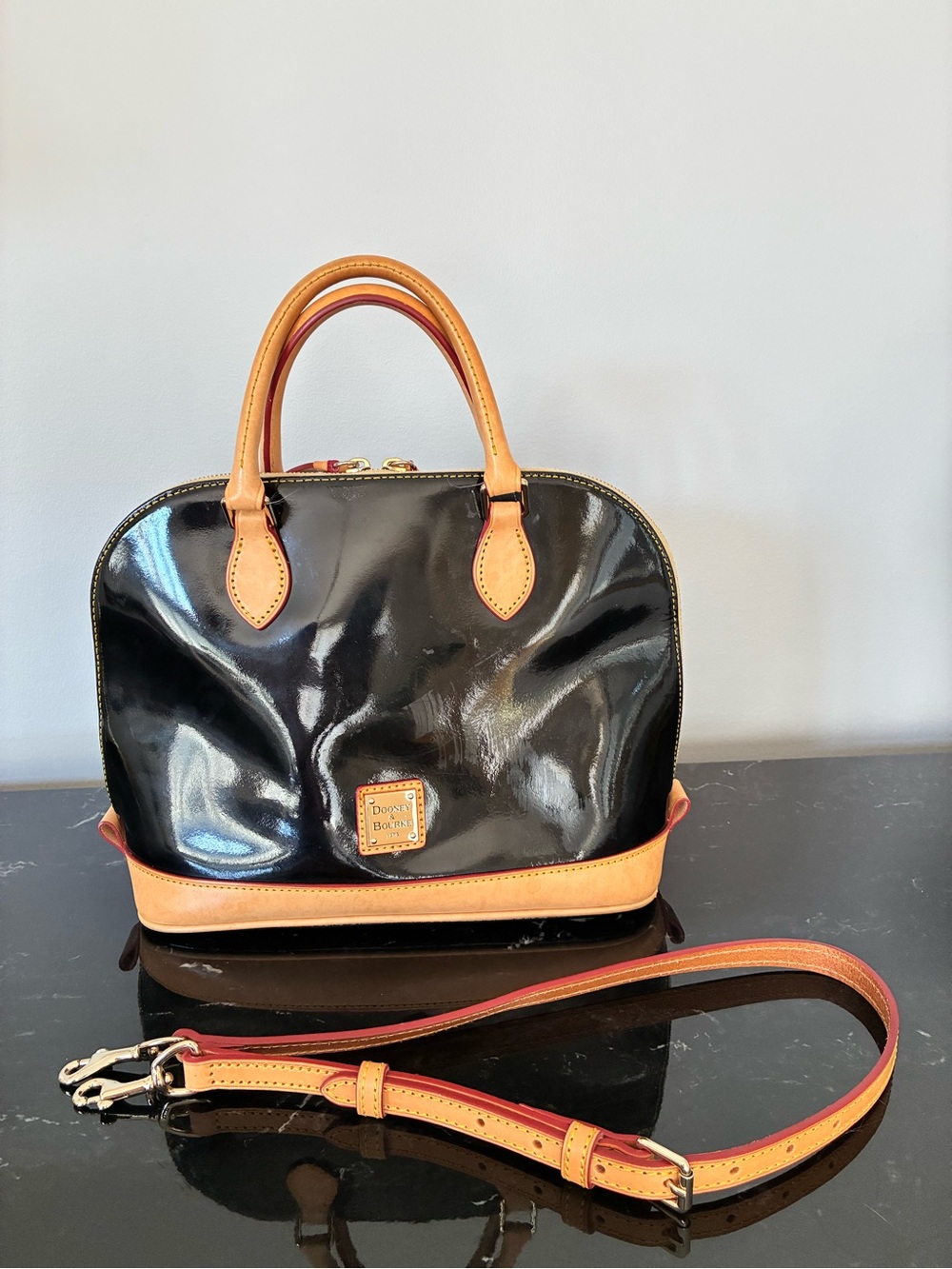 Dooney & Bourke Black Patent Leather Satchel with Tan Trim and Red-Accent Strap